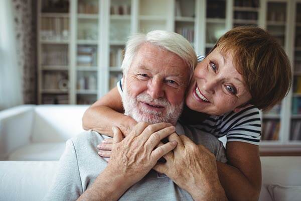 Older couple embracing and smiling
