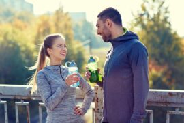 Couple drinking water outdoors