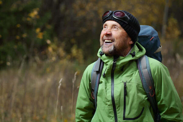 Smiling man hiking in the forest