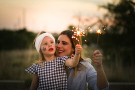 Mother and child holding sparklers